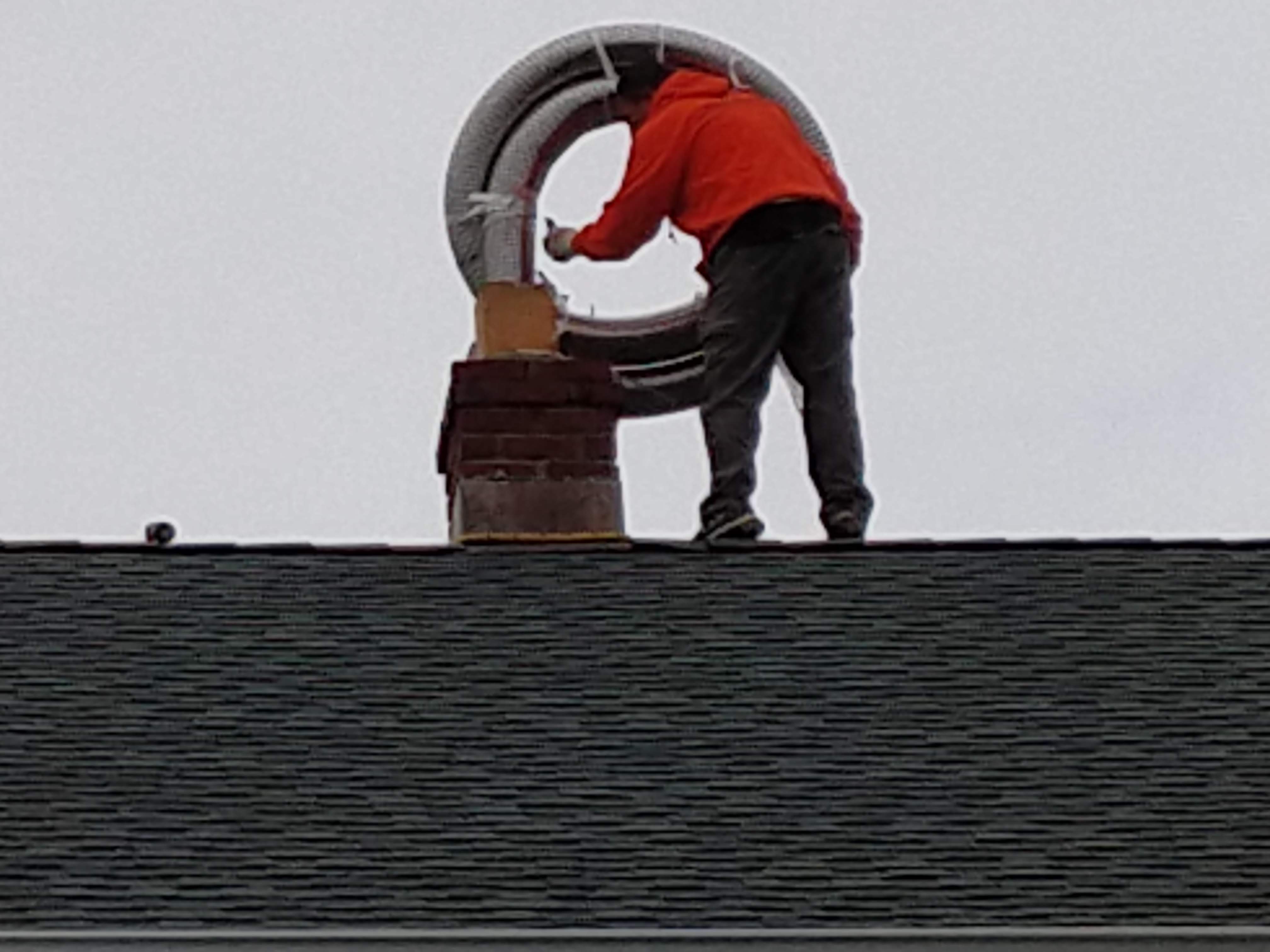 Flexible stainless chimney liner being installed in Roosevelt, New York